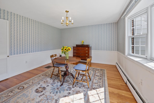 622 Wiese Rd, Cheshire, CT 06410 - dining area featuring a baseboard radiator, wood finished floors, a chandelier, and wallpapered walls