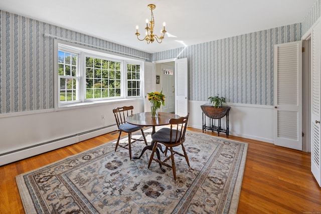 622 Wiese Rd, Cheshire, CT 06410 - dining space with wallpapered walls, a chandelier, a baseboard radiator, wainscoting, and wood finished floors