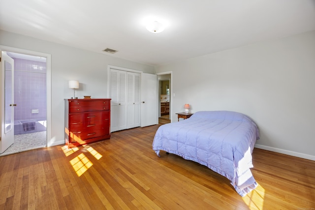 622 Wiese Rd, Cheshire, CT 06410 - bedroom with light wood-type flooring, a closet, and ensuite bath