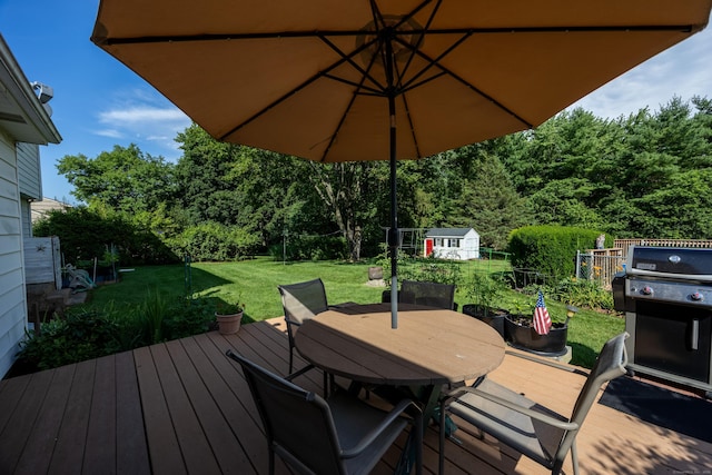 622 Wiese Rd, Cheshire, CT 06410 - wooden deck featuring a shed, outdoor dining area, a lawn, grilling area, and a view of trees