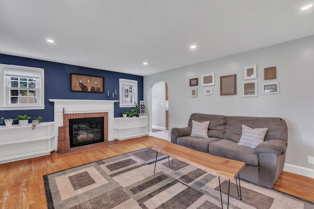 140 Ridgewood Rd, East Hartford, CT 06118 - living area with arched walkways, recessed lighting, hardwood / wood-style floors, and a brick fireplace
