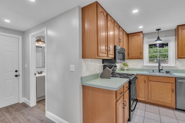 140 Ridgewood Rd, East Hartford, CT 06118 - kitchen with appliances with stainless steel finishes, light countertops, recessed lighting, hanging light fixtures, and light wood finished floors