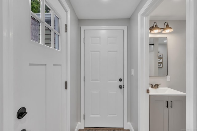140 Ridgewood Rd, East Hartford, CT 06118 - doorway with baseboards and a sink