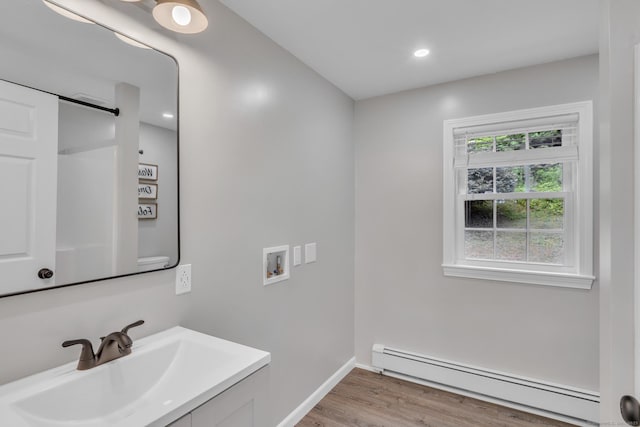 140 Ridgewood Rd, East Hartford, CT 06118 - bathroom with a baseboard heating unit, vanity, wood finished floors, and recessed lighting