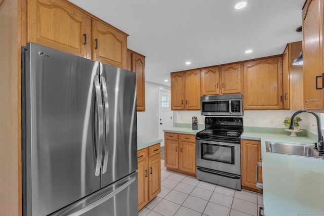 140 Ridgewood Rd, East Hartford, CT 06118 - kitchen featuring appliances with stainless steel finishes, light tile patterned floors, light countertops, recessed lighting, and brown cabinetry