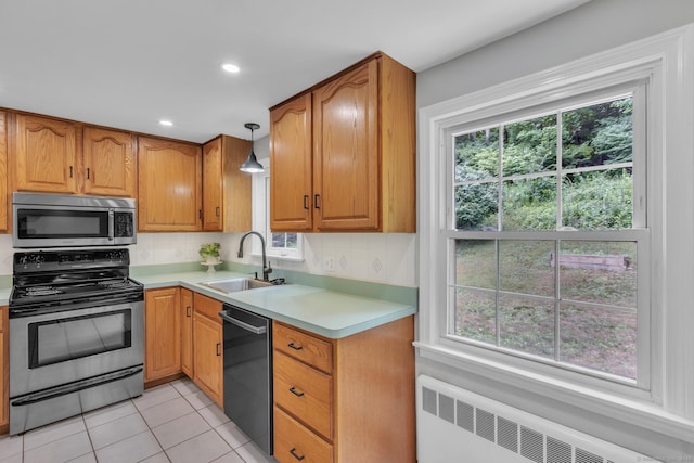 140 Ridgewood Rd, East Hartford, CT 06118 - kitchen with appliances with stainless steel finishes, radiator, light countertops, decorative backsplash, and recessed lighting