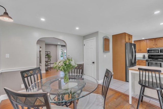 140 Ridgewood Rd, East Hartford, CT 06118 - dining area featuring arched walkways, light wood-style floors, and recessed lighting