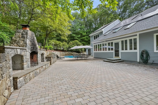 45 Hunting Ridge Rd, Easton, CT 06612 - view of patio / terrace with an outdoor stone fireplace, entry steps, and view of scattered trees