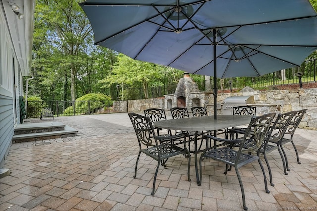 45 Hunting Ridge Rd, Easton, CT 06612 - view of patio / terrace featuring an outdoor stone fireplace, outdoor dining space, and an outdoor kitchen
