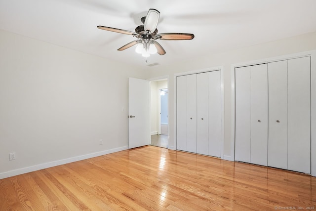 45 Hunting Ridge Rd, Easton, CT 06612 - unfurnished bedroom featuring two closets, wood finished floors, and a ceiling fan