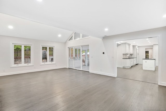 45 Hunting Ridge Rd, Easton, CT 06612 - unfurnished living room featuring wood finished floors, healthy amount of natural light, vaulted ceiling, and recessed lighting