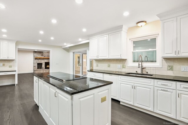 45 Hunting Ridge Rd, Easton, CT 06612 - kitchen with black electric stovetop, a kitchen island, backsplash, white cabinetry, and recessed lighting