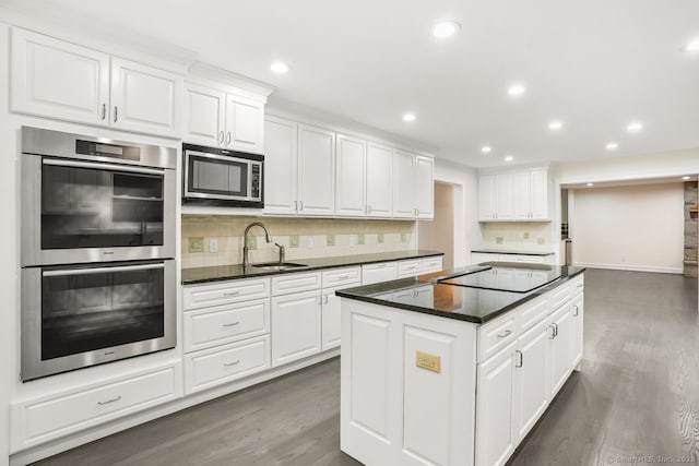 45 Hunting Ridge Rd, Easton, CT 06612 - kitchen featuring appliances with stainless steel finishes, a center island, wood finished floors, decorative backsplash, and white cabinets