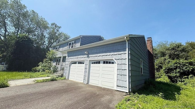 garage with asphalt driveway