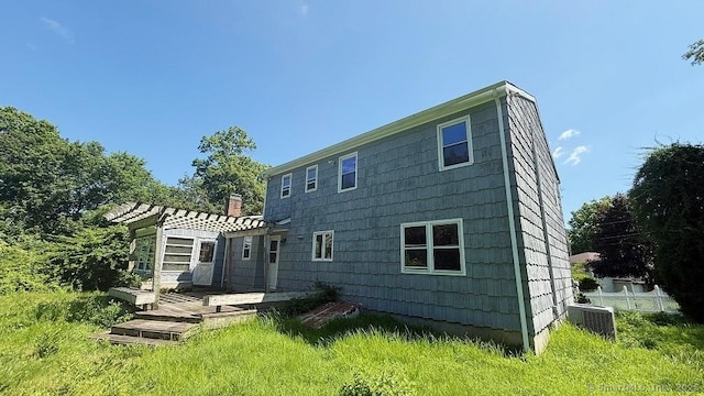 back of property featuring a wooden deck and a chimney