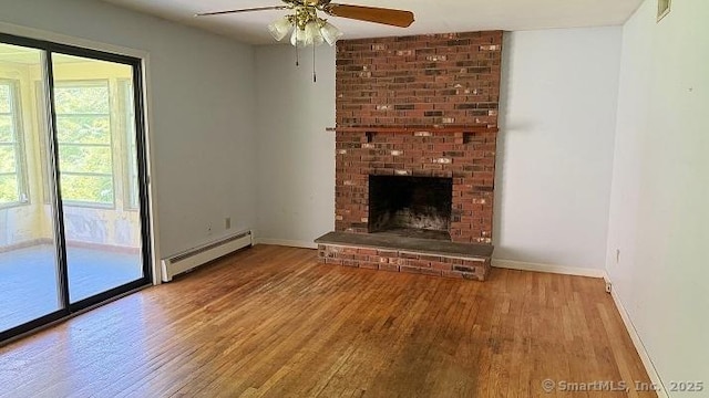 unfurnished living room with a baseboard radiator, wood finished floors, a ceiling fan, and a brick fireplace