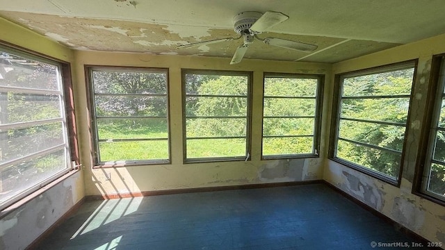 unfurnished sunroom featuring hardwood / wood-style flooring and baseboards