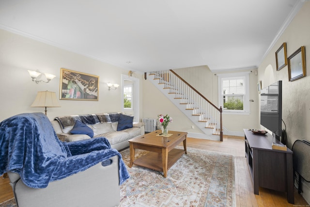 114 Kneeland Rd, New Haven, CT 06512 - living room featuring stairway, wood finished floors, ornamental molding, and radiator