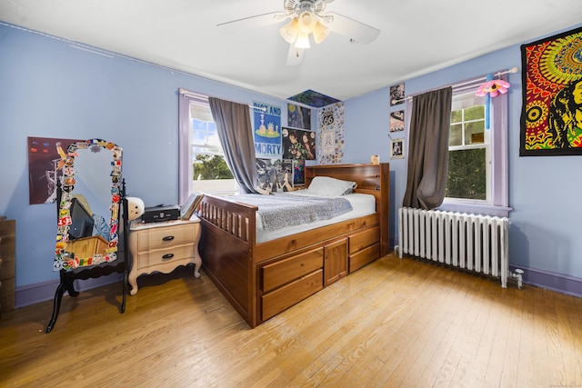 114 Kneeland Rd, New Haven, CT 06512 - bedroom with radiator heating unit, light wood finished floors, multiple windows, and ceiling fan