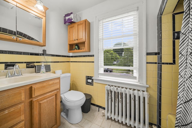 114 Kneeland Rd, New Haven, CT 06512 - full bath featuring radiator heating unit, tile walls, vanity, tile patterned floors, and wainscoting
