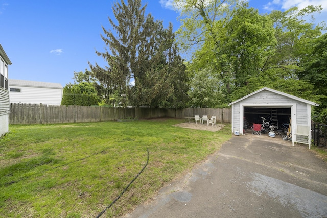 114 Kneeland Rd, New Haven, CT 06512 - fenced backyard featuring a detached garage, driveway, and an outbuilding