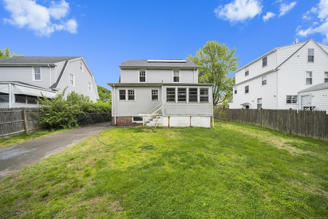 114 Kneeland Rd, New Haven, CT 06512 - rear view of house with entry steps, roof mounted solar panels, and a fenced backyard