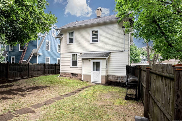 38 Francis Ave, Hamden, CT 06517 - rear view of property featuring a fenced backyard, a chimney, and roof with shingles