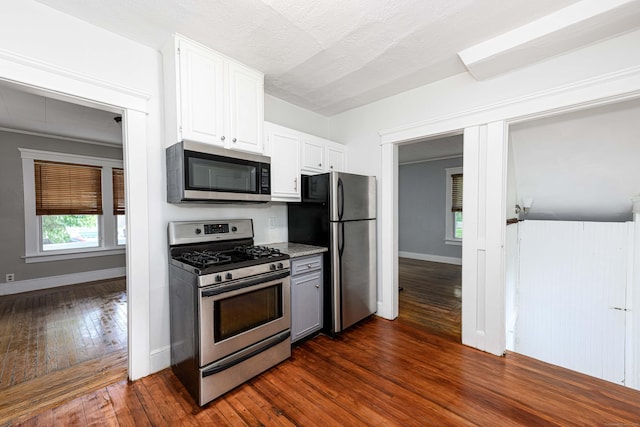 38 Francis Ave, Hamden, CT 06517 - kitchen with stainless steel appliances, dark wood-style floors, and white cabinets