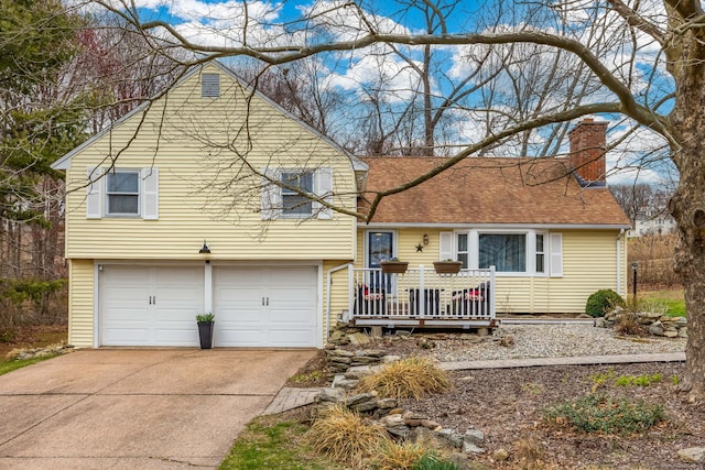438 Woodland St, Glastonbury, CT 06073 - split level home featuring a chimney, an attached garage, driveway, a deck, and a shingled roof