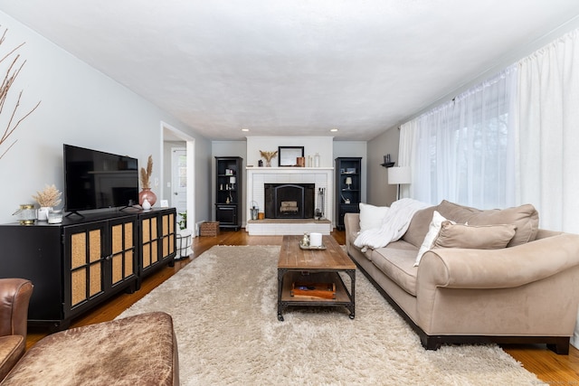 438 Woodland St, Glastonbury, CT 06073 - living area with wood finished floors and a brick fireplace