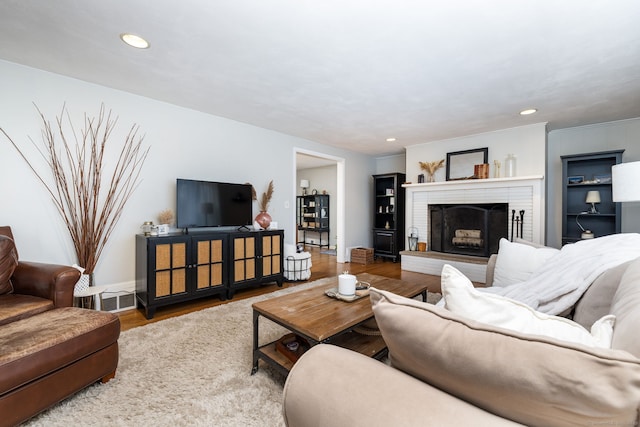 438 Woodland St, Glastonbury, CT 06073 - living room with wood finished floors, a fireplace, and recessed lighting
