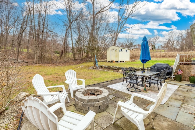 438 Woodland St, Glastonbury, CT 06073 - view of patio / terrace featuring a fire pit, a shed, and outdoor dining area