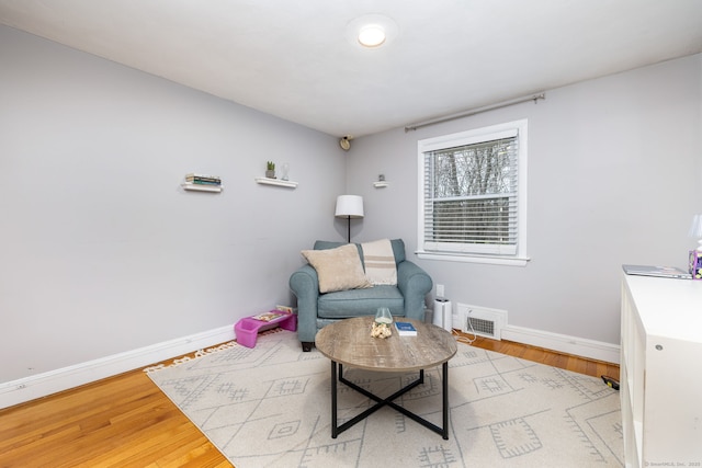 438 Woodland St, Glastonbury, CT 06073 - living area featuring baseboards and wood finished floors