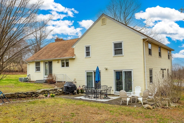 438 Woodland St, Glastonbury, CT 06073 - rear view of property with a chimney, a patio, a yard, roof with shingles, and entry steps