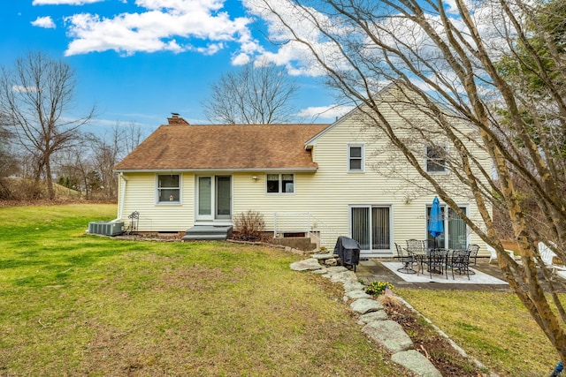 438 Woodland St, Glastonbury, CT 06073 - rear view of house with a patio area, a chimney, a yard, entry steps, and a shingled roof