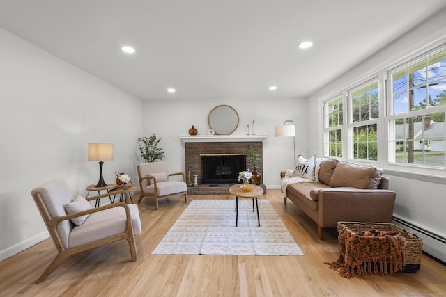 103 Perry Rd, Bristol, CT 06010 - living area featuring recessed lighting, light wood-style floors, a baseboard heating unit, and a fireplace