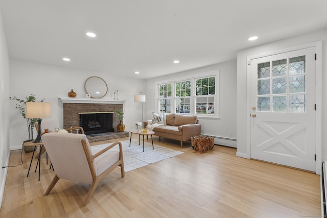 103 Perry Rd, Bristol, CT 06010 - living area with baseboard heating, light wood finished floors, a brick fireplace, and recessed lighting