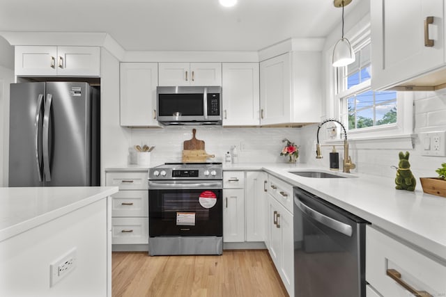 103 Perry Rd, Bristol, CT 06010 - kitchen with stainless steel appliances, light countertops, white cabinets, and backsplash