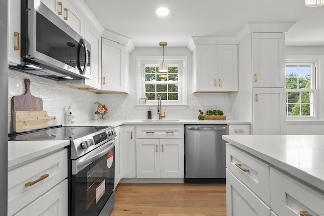 103 Perry Rd, Bristol, CT 06010 - kitchen with stainless steel appliances, plenty of natural light, light countertops, and white cabinetry