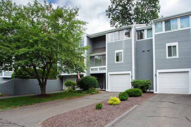 14 Old Mill Ct Unit 14, Simsbury, CT 06070 - view of building exterior with an attached garage and asphalt driveway