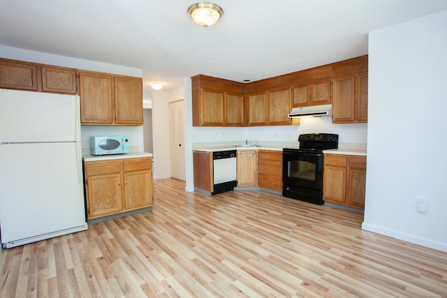 14 Old Mill Ct Unit 14, Simsbury, CT 06070 - kitchen featuring white appliances, under cabinet range hood, light wood-style flooring, and light countertops