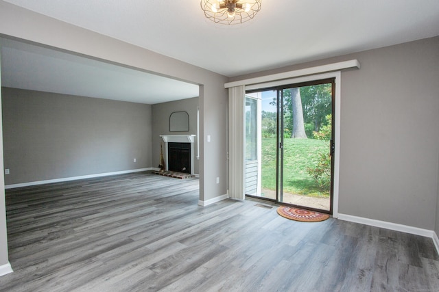 14 Old Mill Ct Unit 14, Simsbury, CT 06070 - unfurnished living room featuring wood finished floors and a brick fireplace