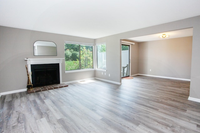 14 Old Mill Ct Unit 14, Simsbury, CT 06070 - unfurnished living room with a fireplace with raised hearth and wood finished floors