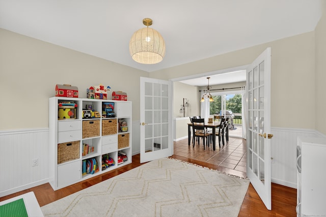 26 Rockwood Dr, Portland, CT 06480 - bedroom with french doors, wainscoting, and wood finished floors