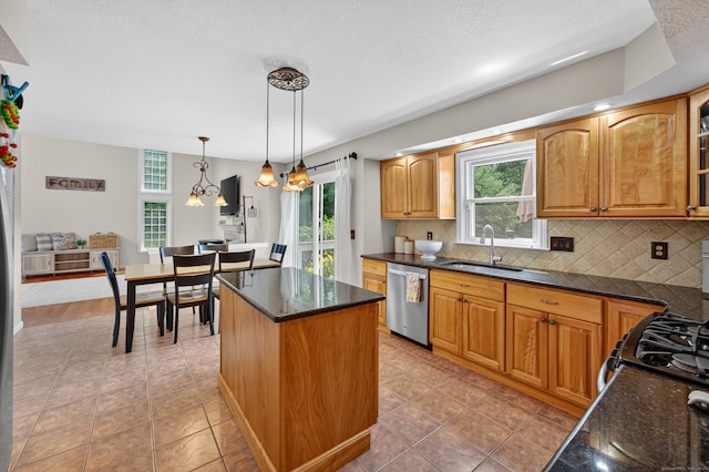 26 Rockwood Dr, Portland, CT 06480 - kitchen with dishwasher, healthy amount of natural light, backsplash, a kitchen island, and a textured ceiling
