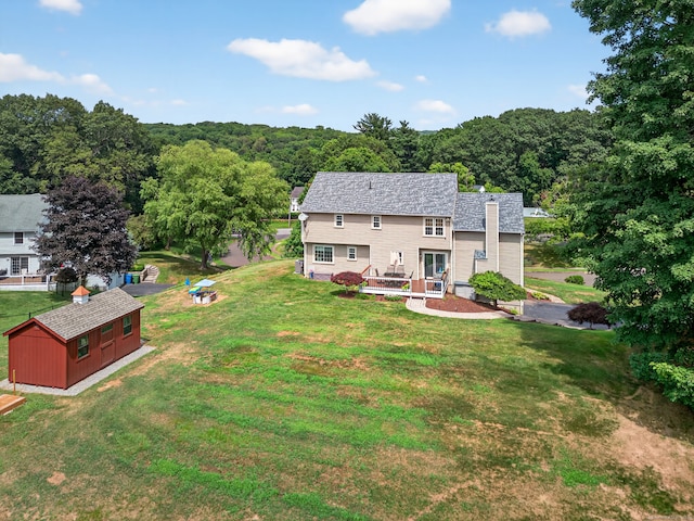 26 Rockwood Dr, Portland, CT 06480 - rear view of house featuring a storage unit, a lawn, a view of trees, and a deck