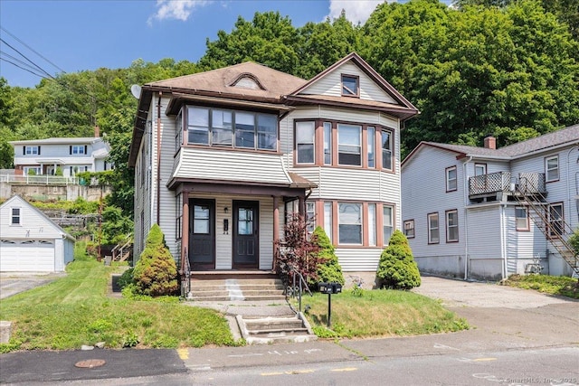 118 New Haven Ave, Derby, CT 06418 - view of front of home with covered porch, a front lawn, and a garage
