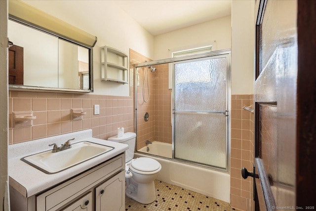 118 New Haven Ave, Derby, CT 06418 - full bath with tile walls, vanity, combined bath / shower with glass door, tile patterned flooring, and wainscoting