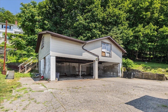 118 New Haven Ave, Derby, CT 06418 - view of front of property featuring stairway, driveway, and a carport