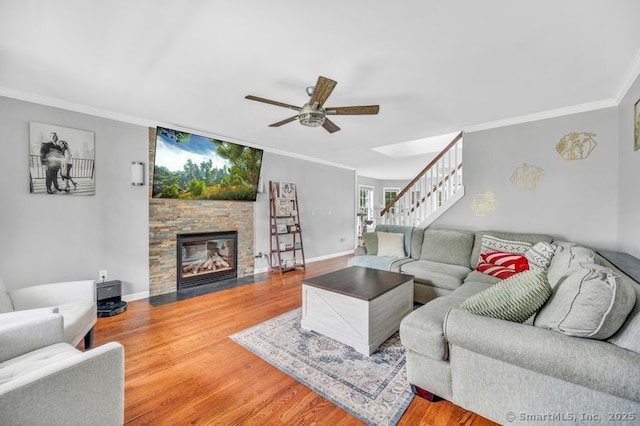 51 Olde Village Cir Unit 51, Wallingford, CT 06492 - living room with ornamental molding, ceiling fan, stairs, wood finished floors, and a fireplace